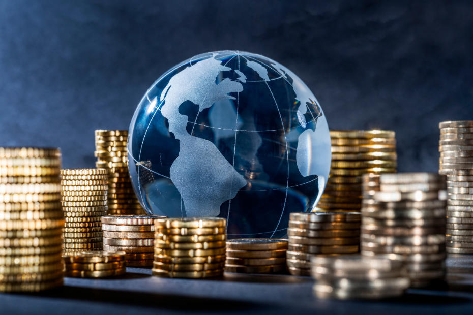 globe surrounded by stacks of coins
