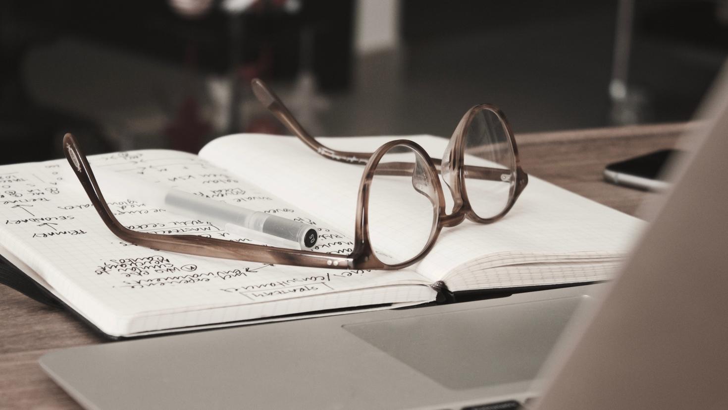 Pair of glasses on a book