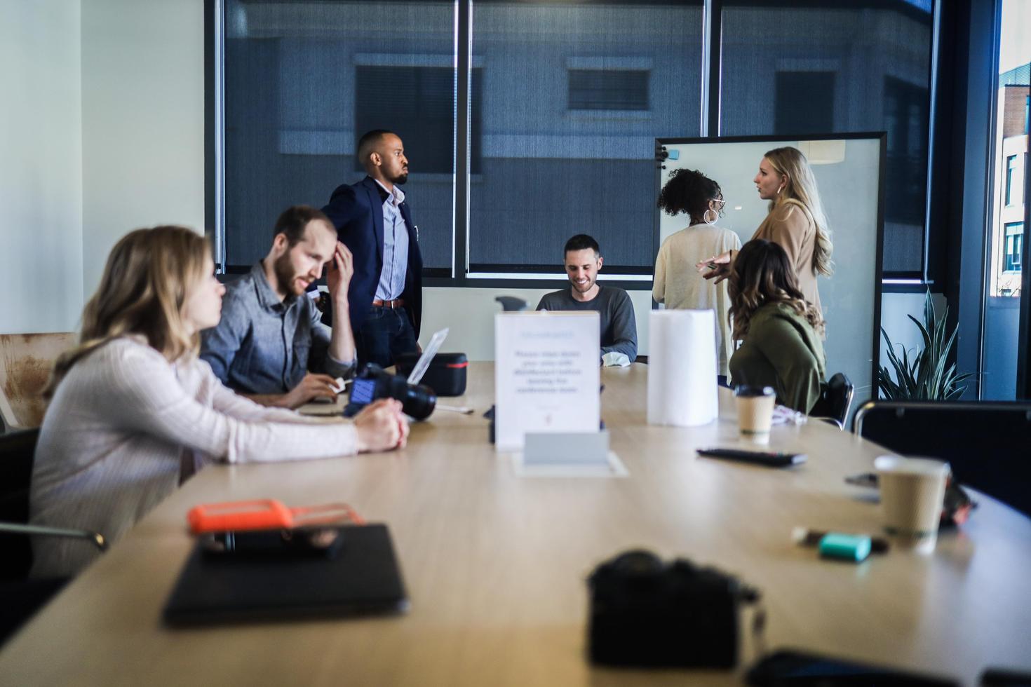 Group of researchers working in a room around a table