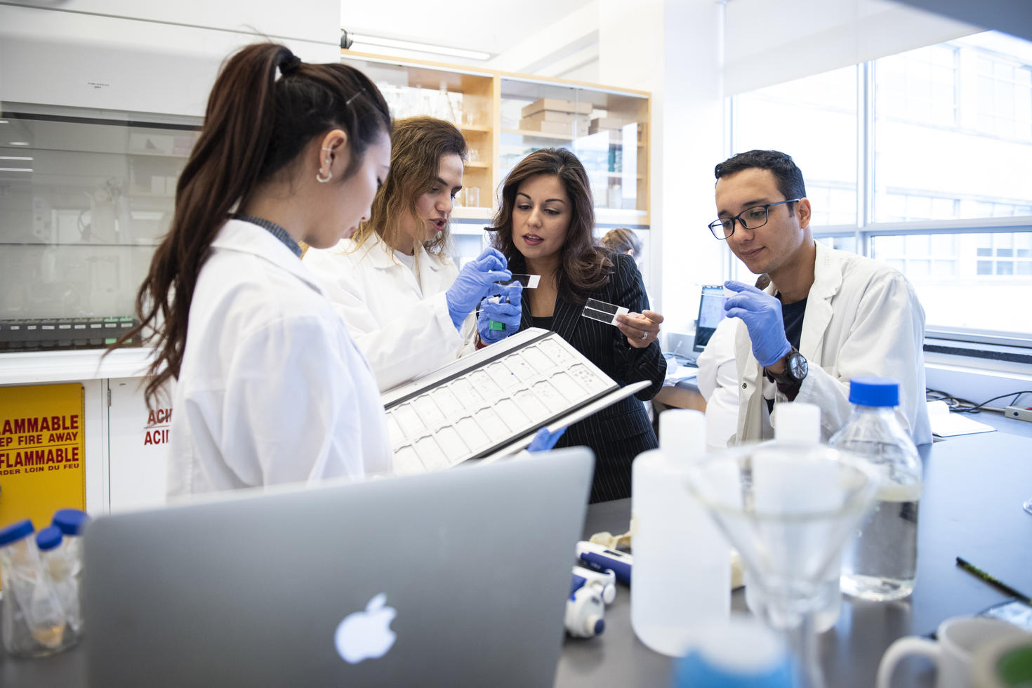 Group of people working collaboratively in lab.