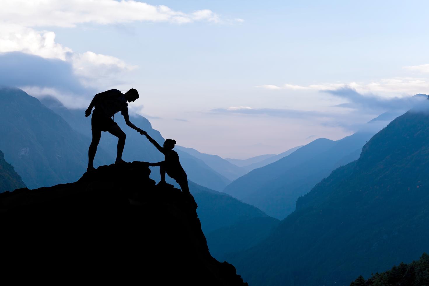 Mountain climbers helping each other.