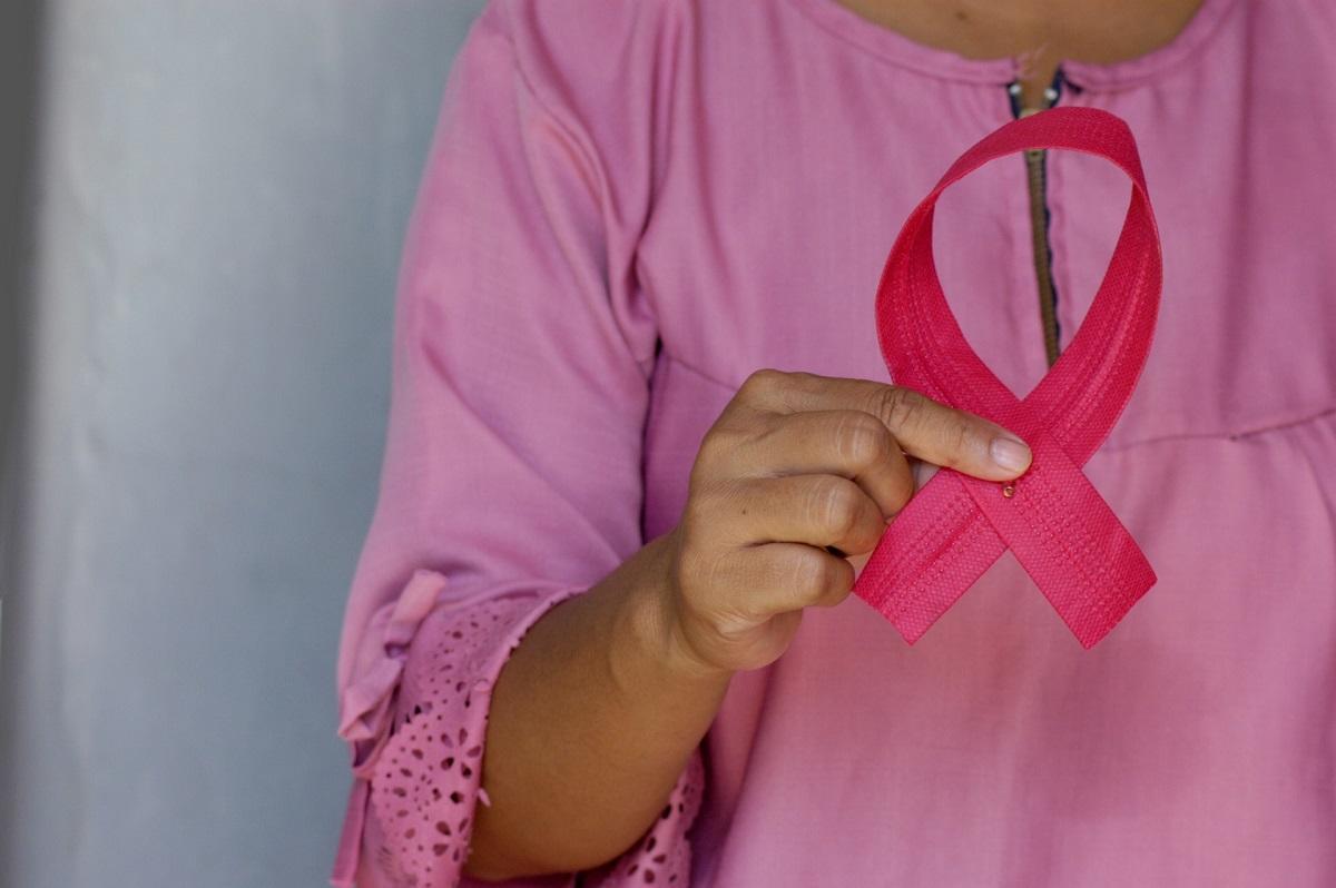 Woman holding pink breast cancer ribbon