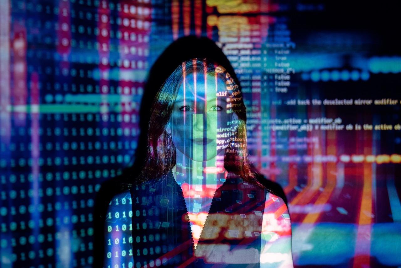 Silhouette of woman behind a glass wall of colored data 