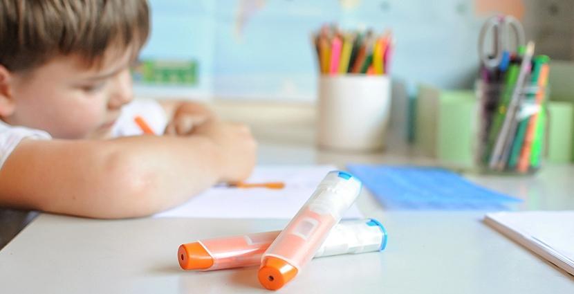Child with EpiPen on the table