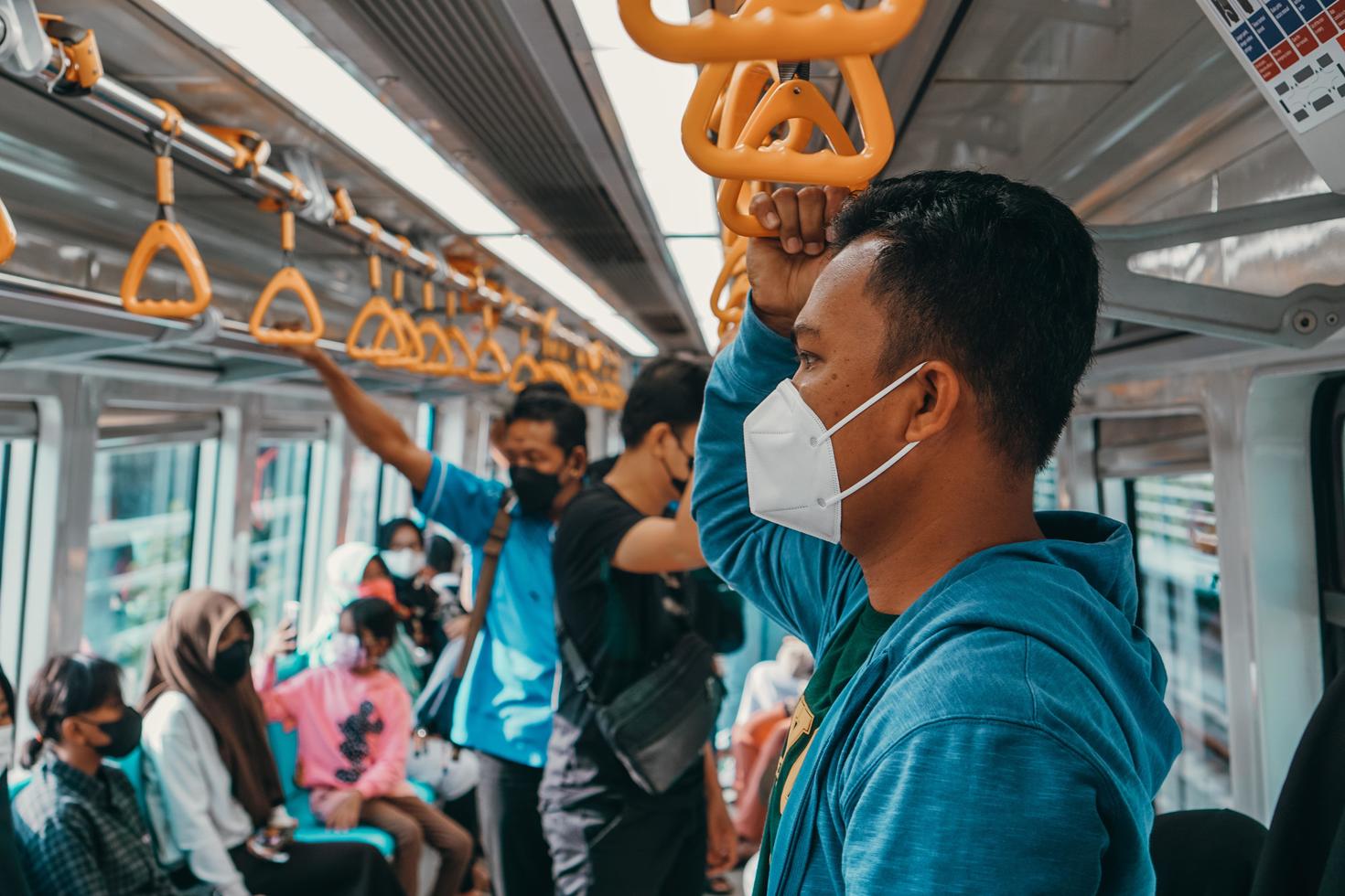 Masked public transit passengers..