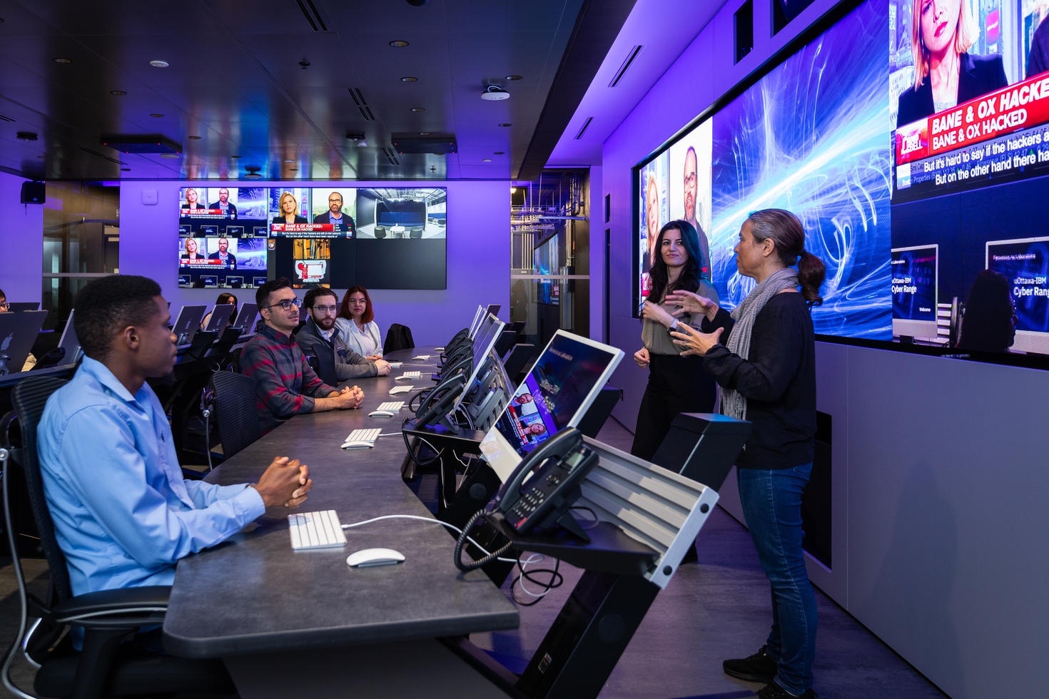 Professors training students in the uOttawa-IBM Cyber Range