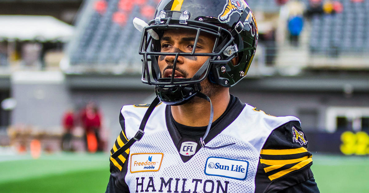 Portrait of Jackson Bennett wearing the Tiger-Cats helmet on the football field
