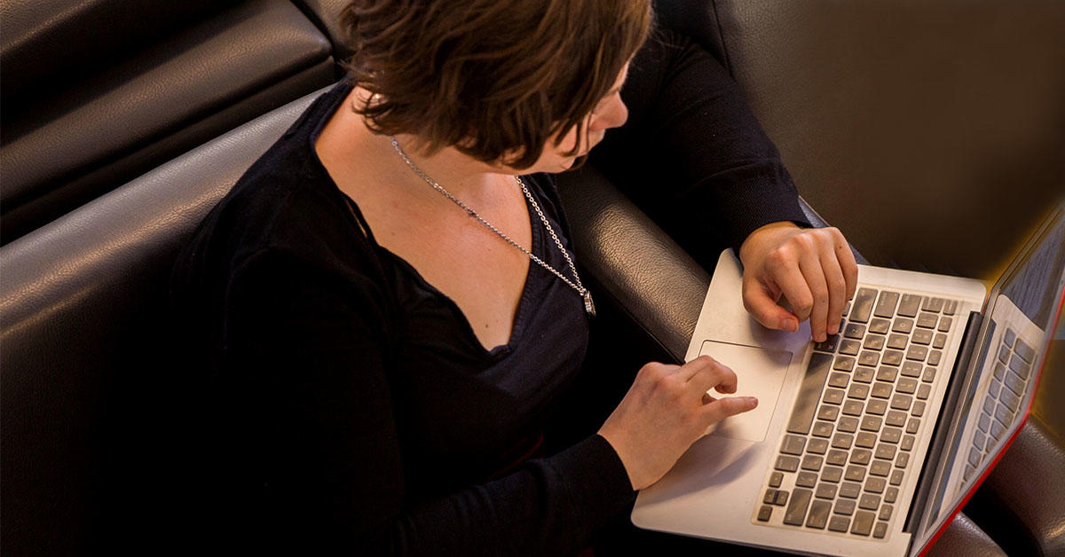 image of woman typing on laptop keyboard