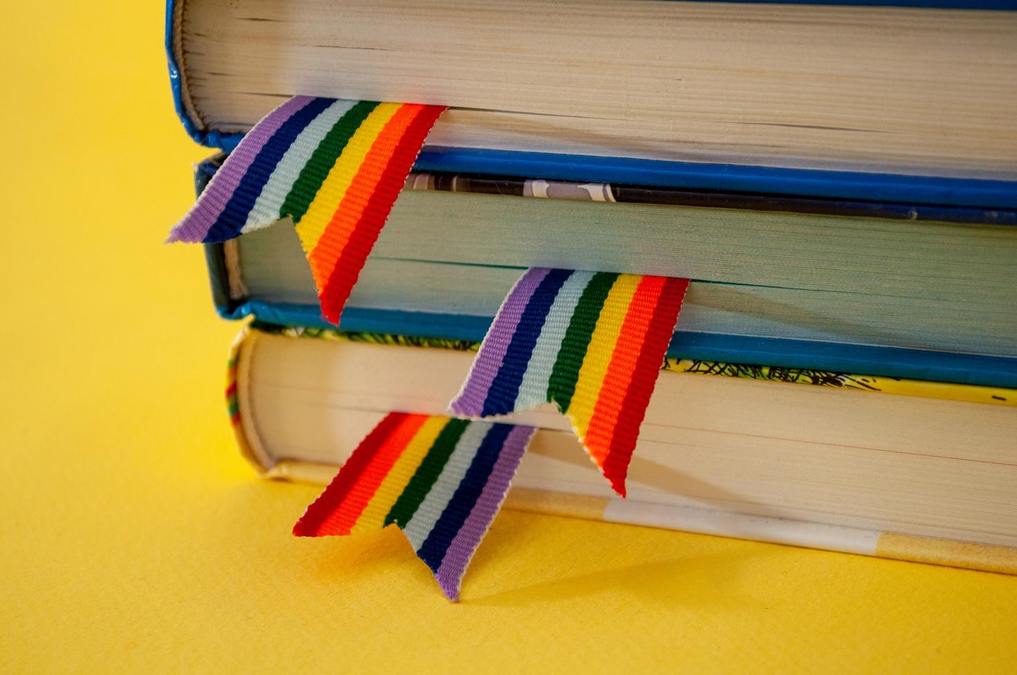 Stack of books with rainbow ribbon