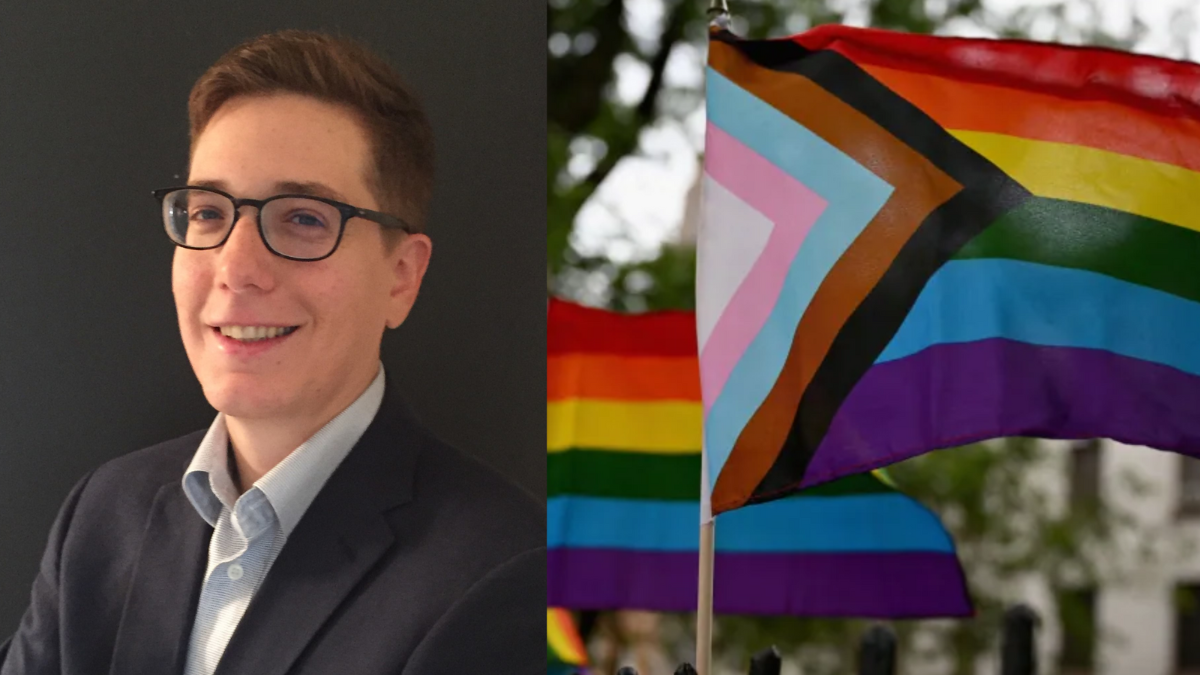 Professor Sam Singer opposite the Progress Pride Flag