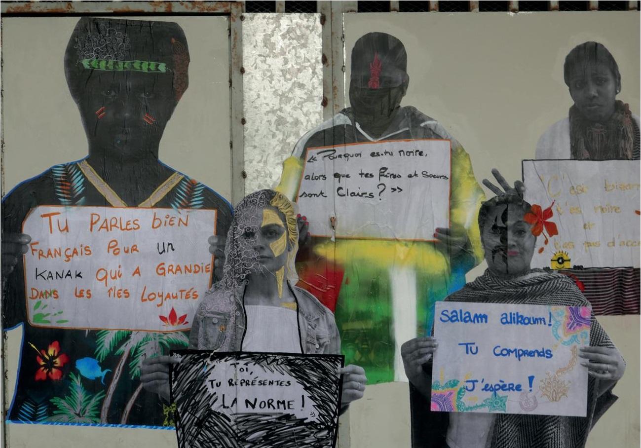 5 women holding signs they have written facing the camera