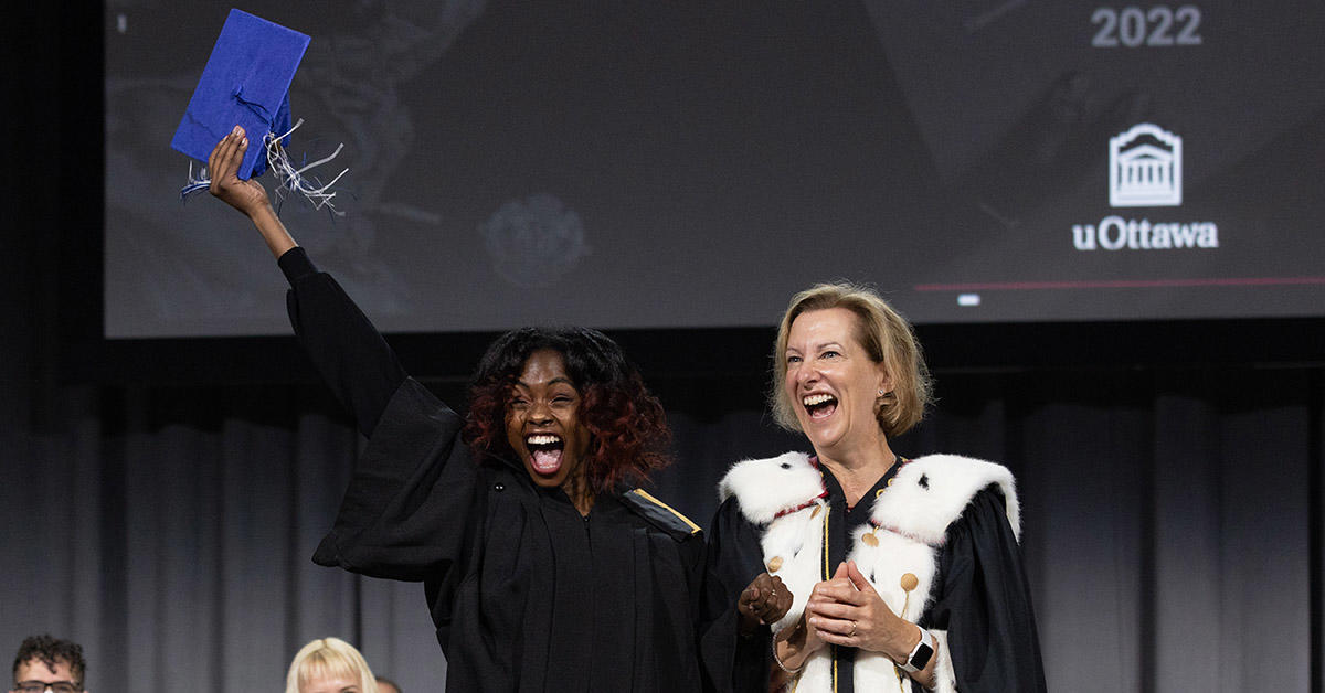 Social sciences graduate cheers while on stage at convocation