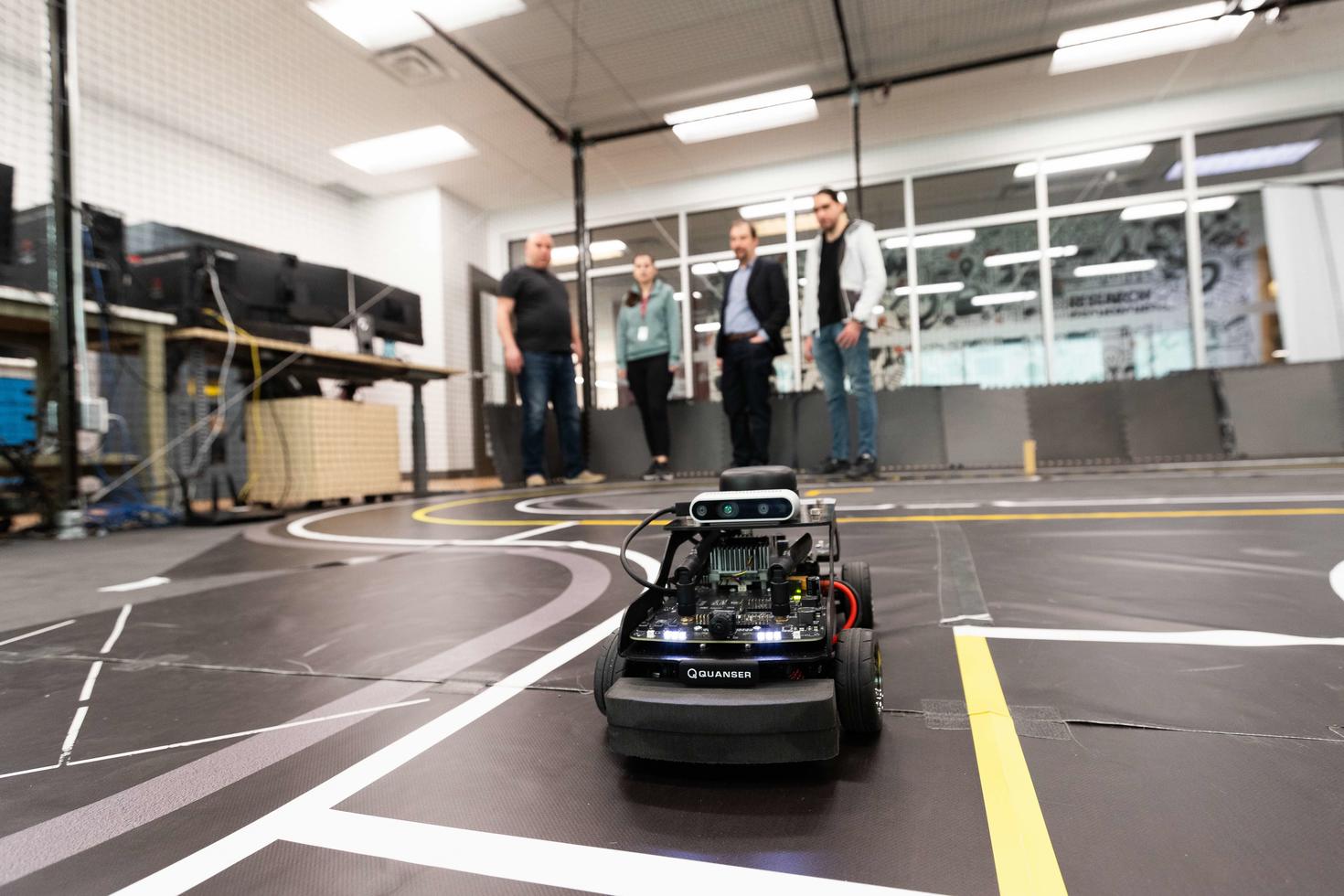 Kanata North colleagues testing out a robotic car.