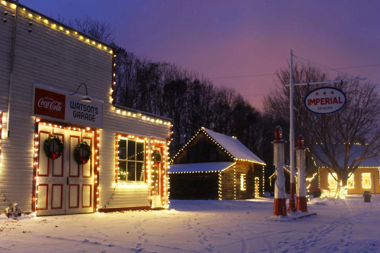 An old garage lit up with Christmas lights.