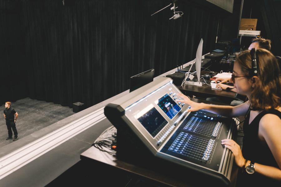 A person working at a sound board.