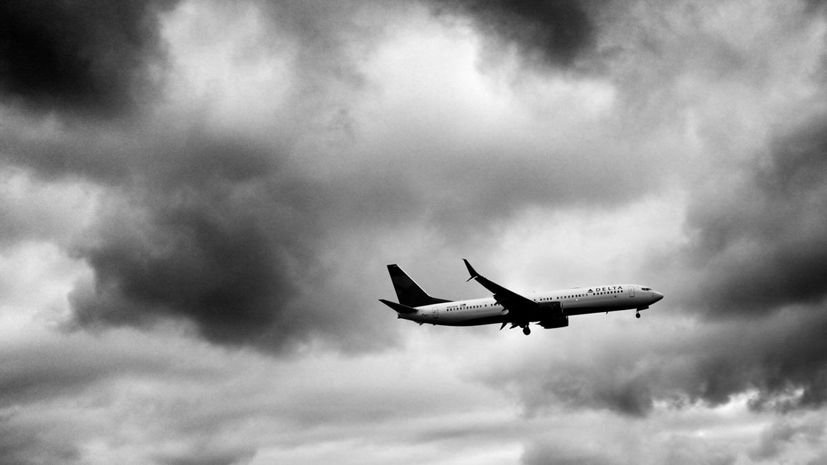 Black and white image of Delta plane in sky