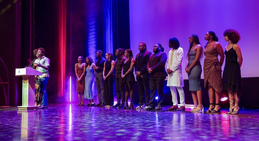 A group of around a dozen Black students on stage at the 2025 Black Excellence Awards gala.