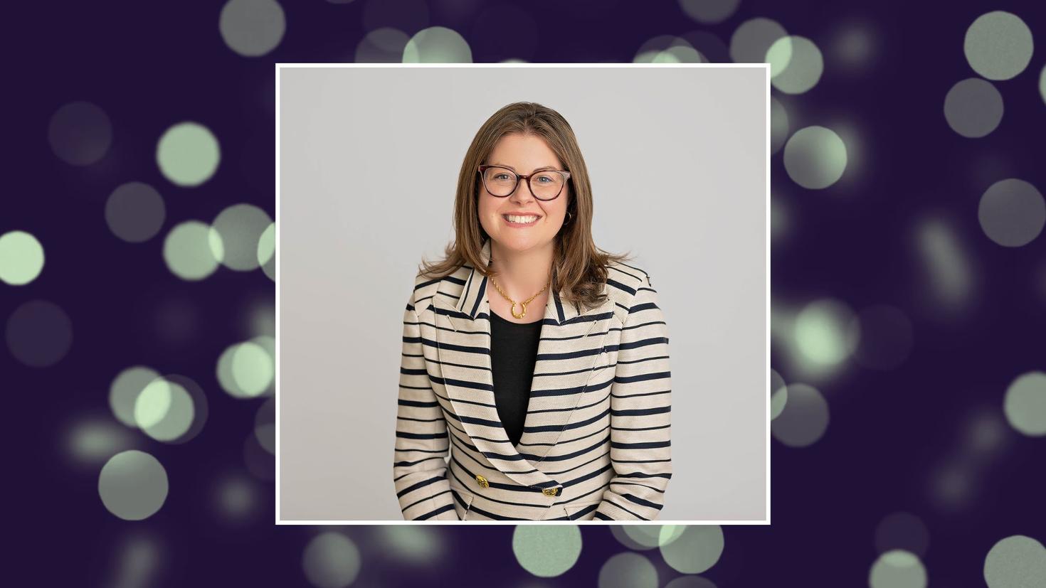 Portrait of a female professor with a purple background