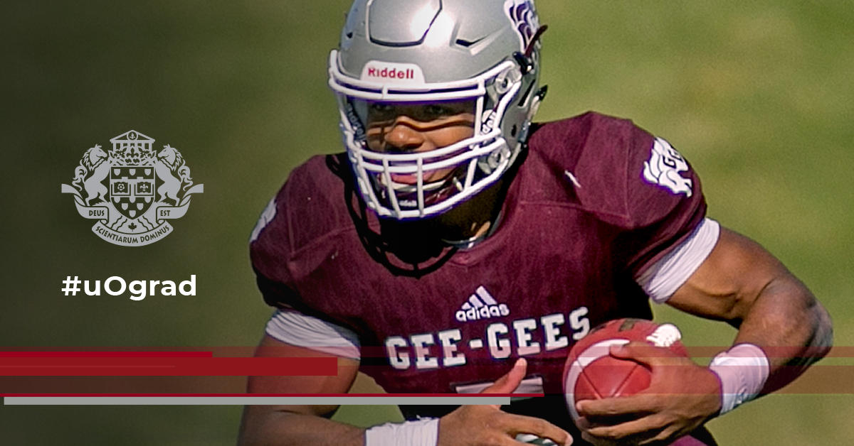 Gee-Gees football player Jackson Bennett runs with the football ball in in hands