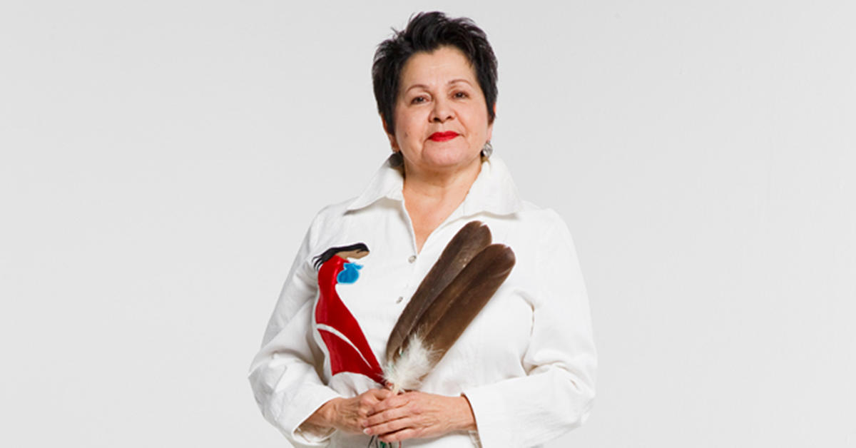 Elder Claudette Commanda holding an eagle feather