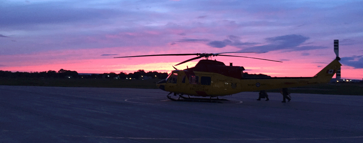 helicopter and bright pink sunset