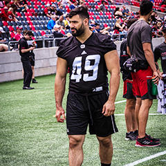 Ettore Lattanzio stands on the sideline during practice.