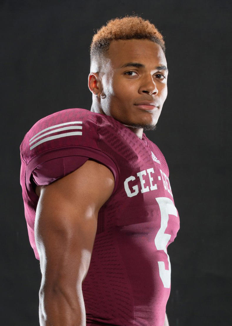 Portrait of Jackson Bennett wearing Gee-Gees football jerseyson Bennett wearing the Tiger-Cats helmet on the football field