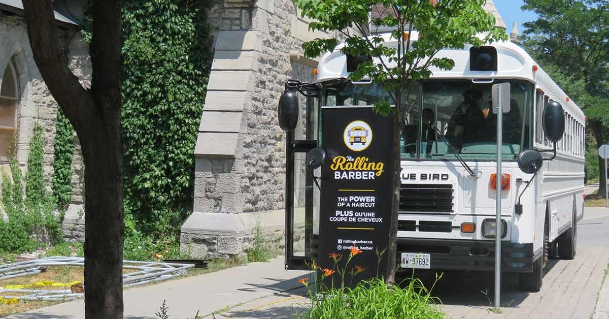 Bus seen from the front, next to a church.