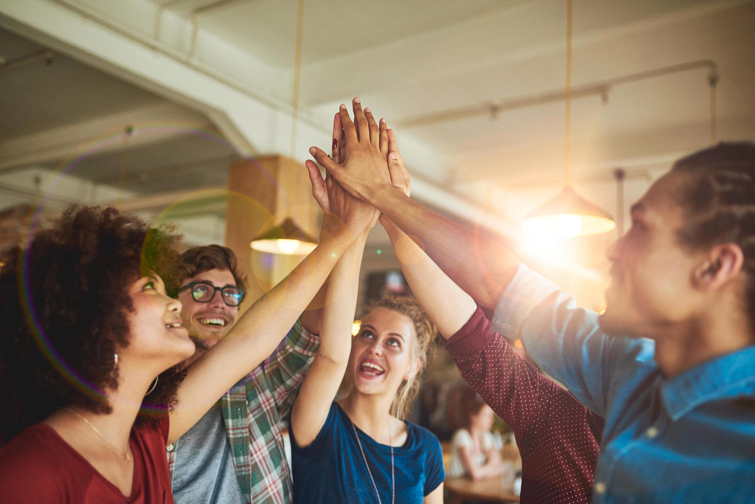 Équipe joignant les mains au-dessus de la tête en signe d'encouragement