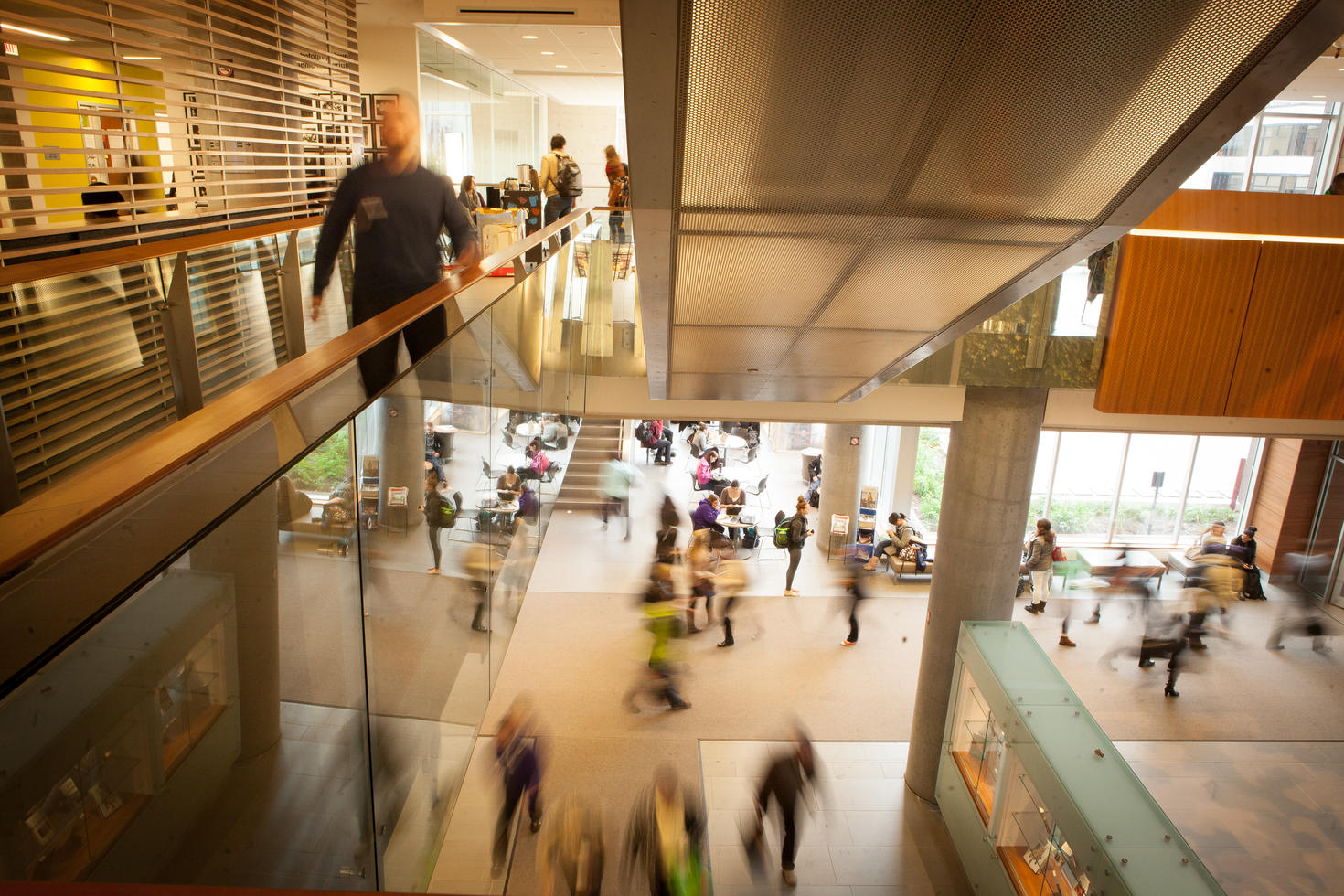 Interior of the Social Sciences Building atrium. View of people on two floors and stairwell going up.