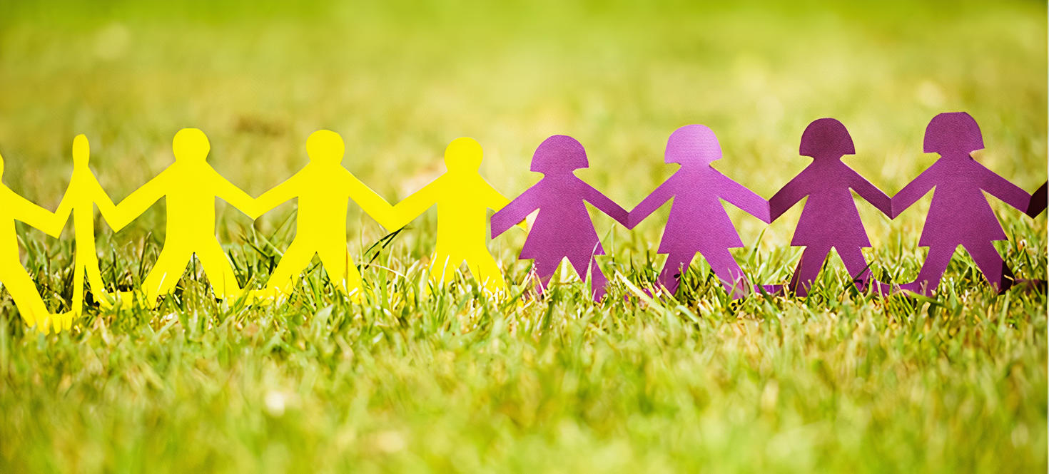 Paper cutouts of individuals holding hands in two colours