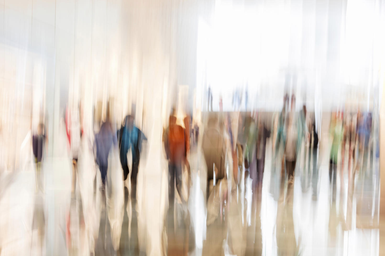 Blurred image of several people walking 