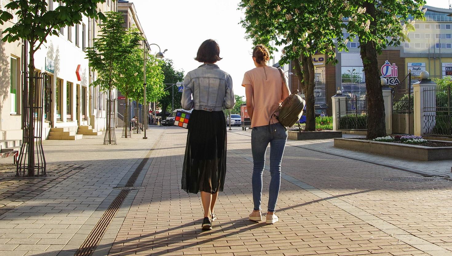 2 people walking away from us 
