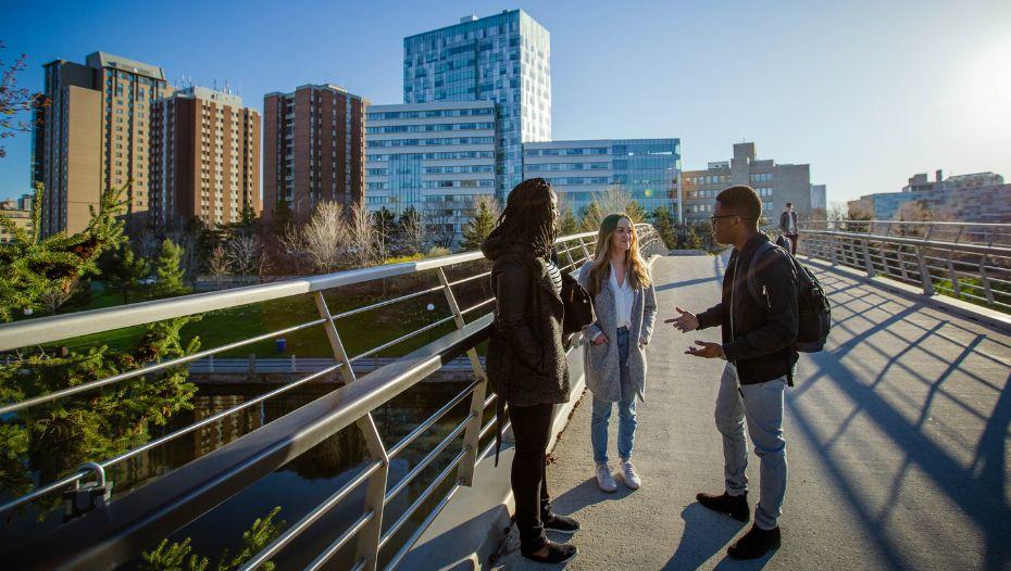 three students on a bridge 