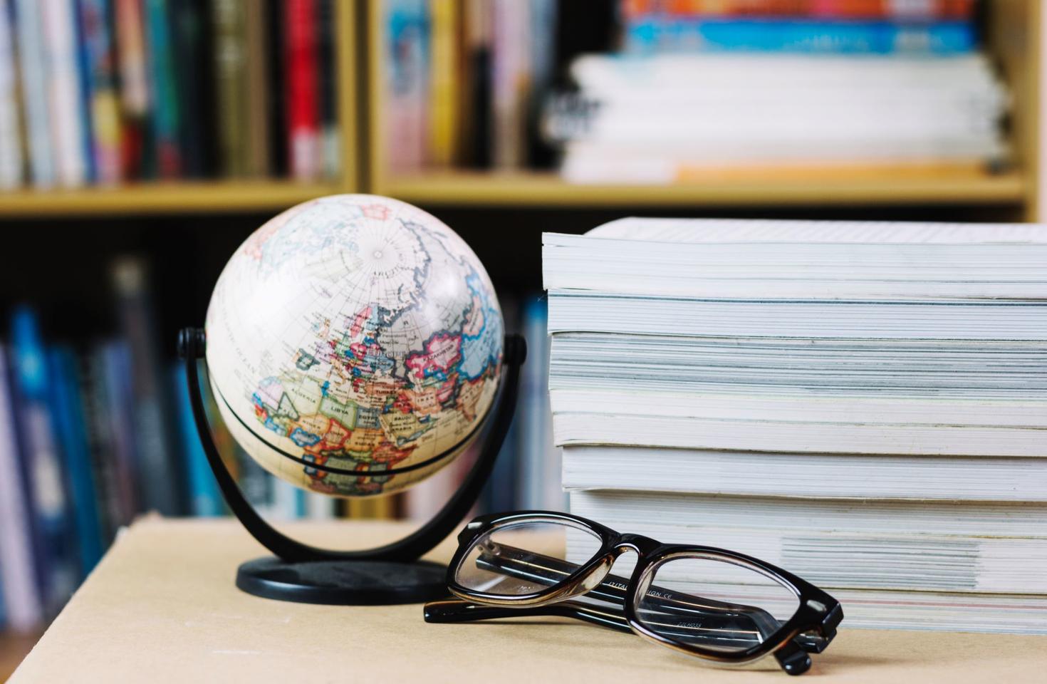 World globe, glasses and books in library