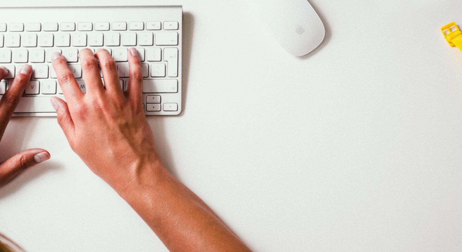 hands on a white keyboard 