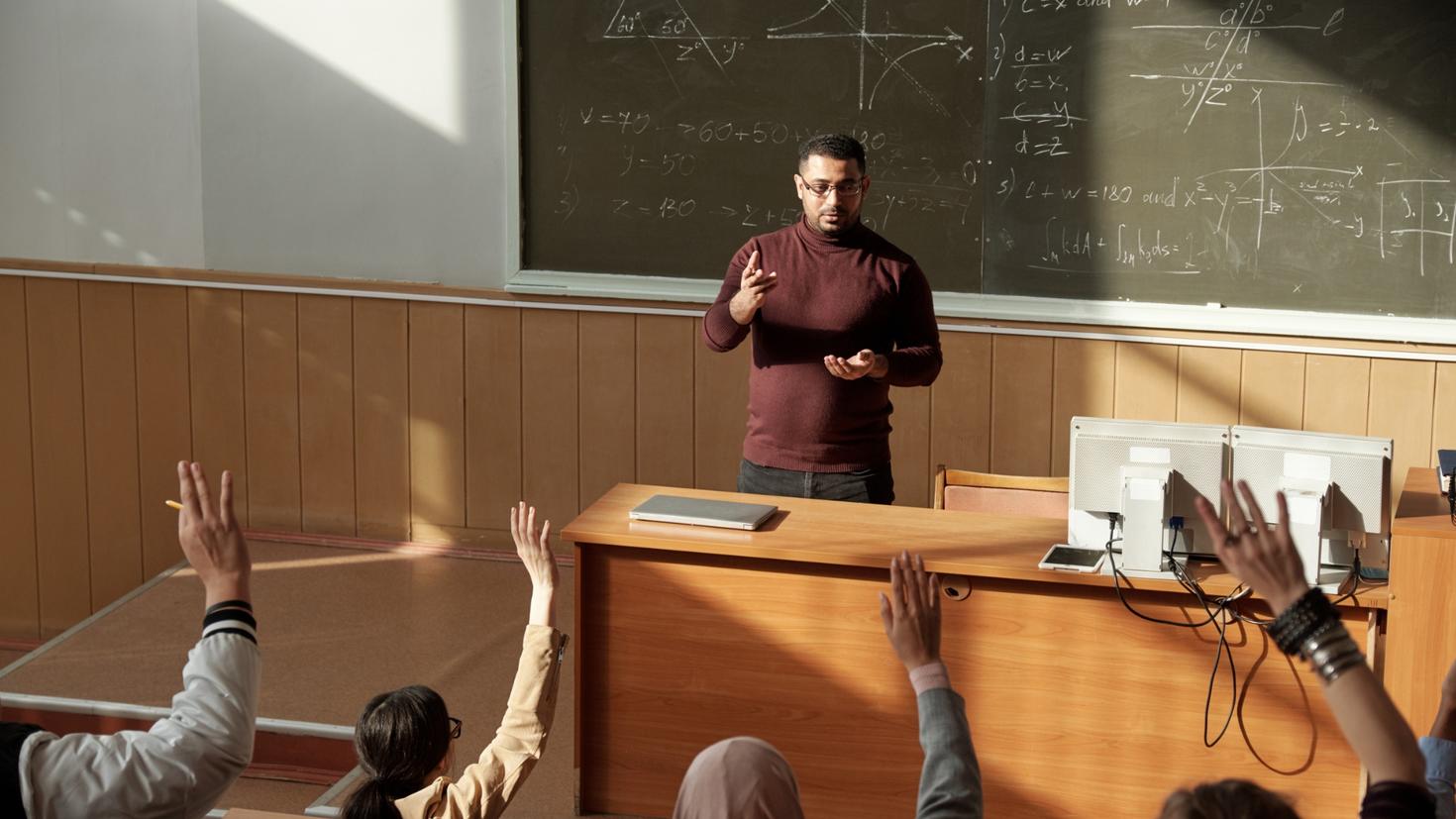 professor teaching economics graduates studies