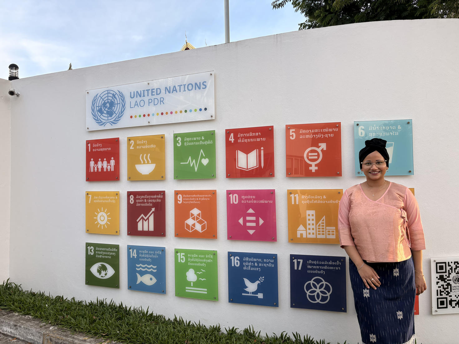 Student with United Nations LAO PDR wall