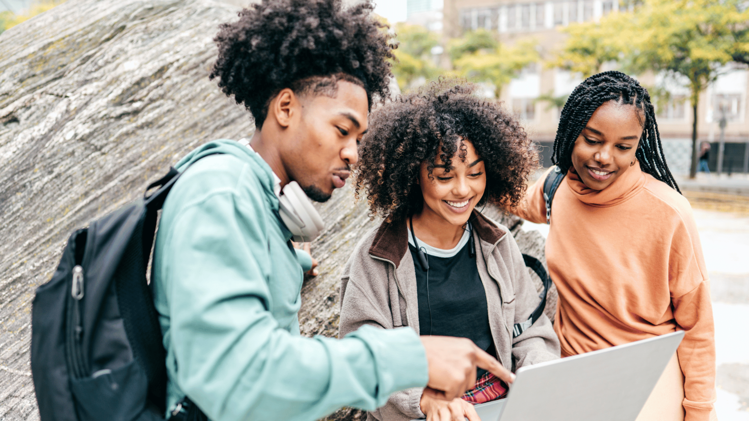 Three students looking at a computer