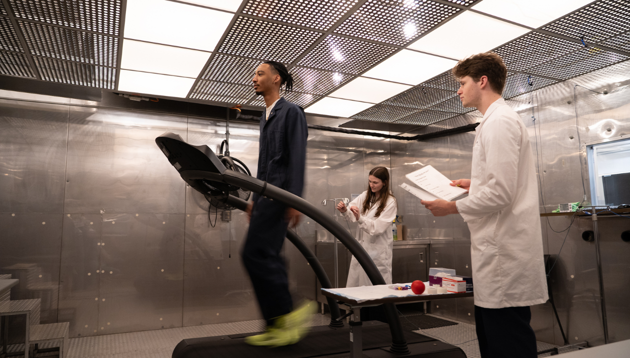Researchers monitor a treadmill exercise in a lab.