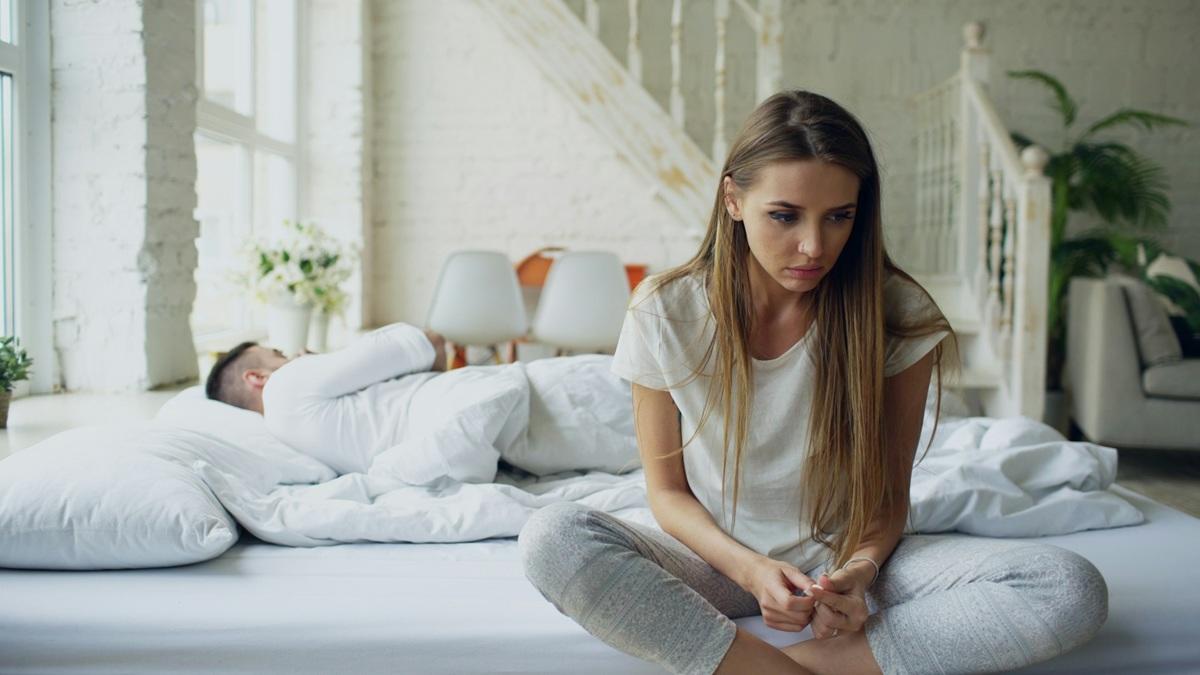 Woman and man in bed after a fight