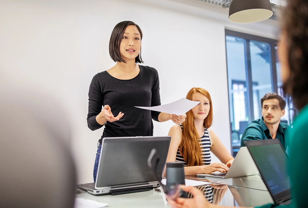 A woman presenting in a group meeting