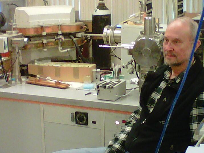 Clem Kazakoff sitting near a spectrophotometer