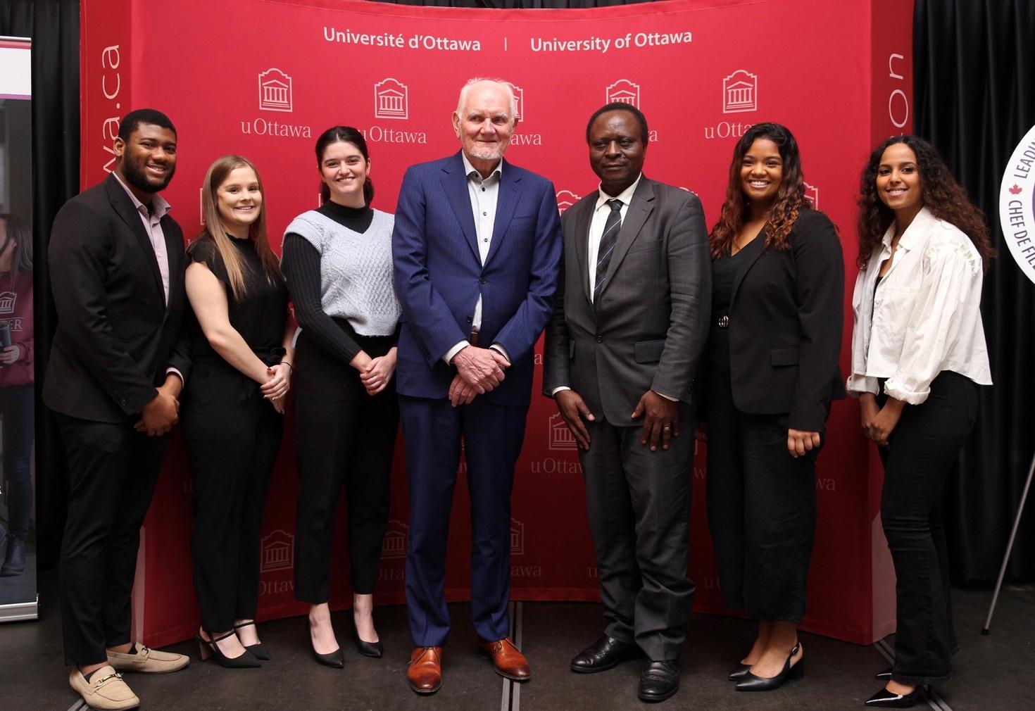 Camille Villeneuve with current and former Telfer students who were helped by his generosity.