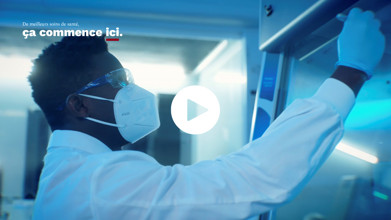 Personne écrivant sur un tableau avec un bouton de lecture en surimpression, avec le slogan De meilleurs soins de santé ça commence ici.