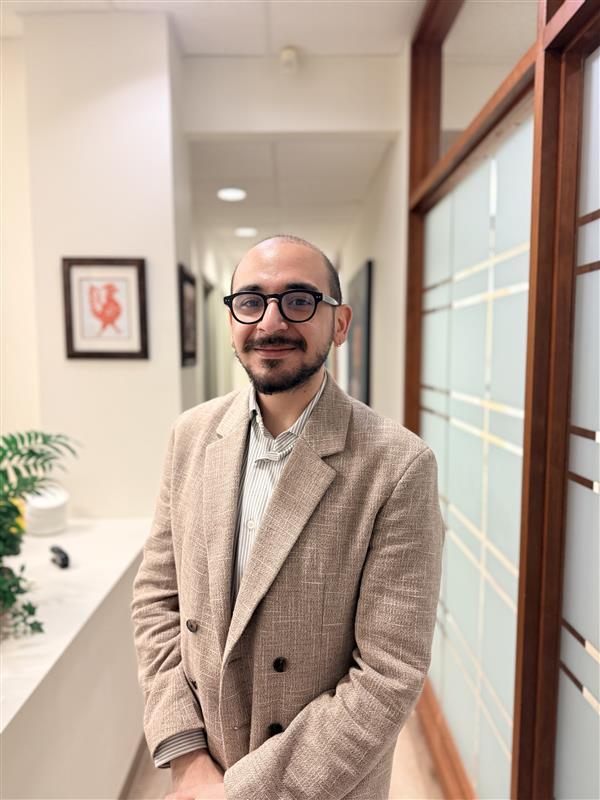 Nadim Saadeh standing in a bright hallway.