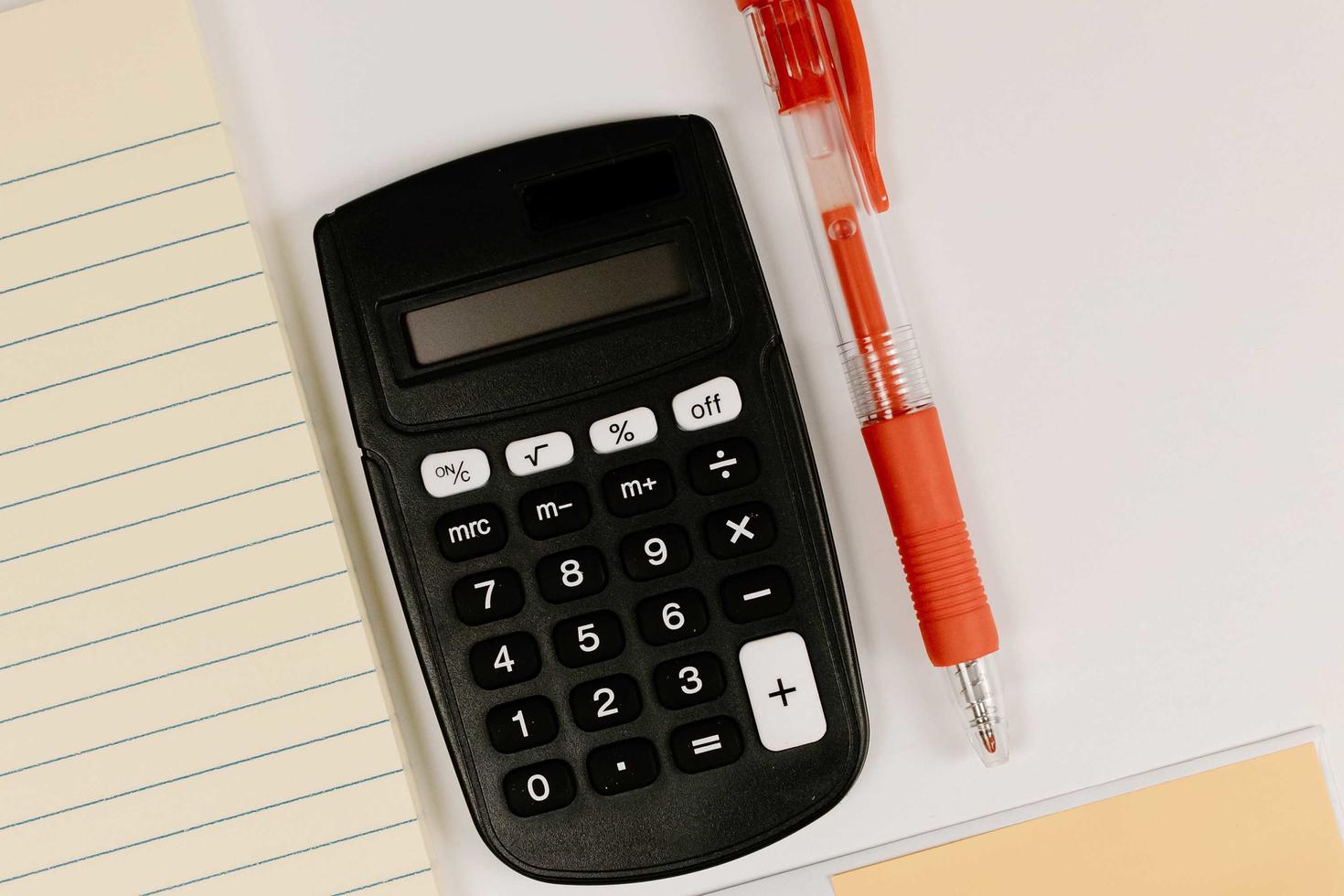 Calculator a pen and papers