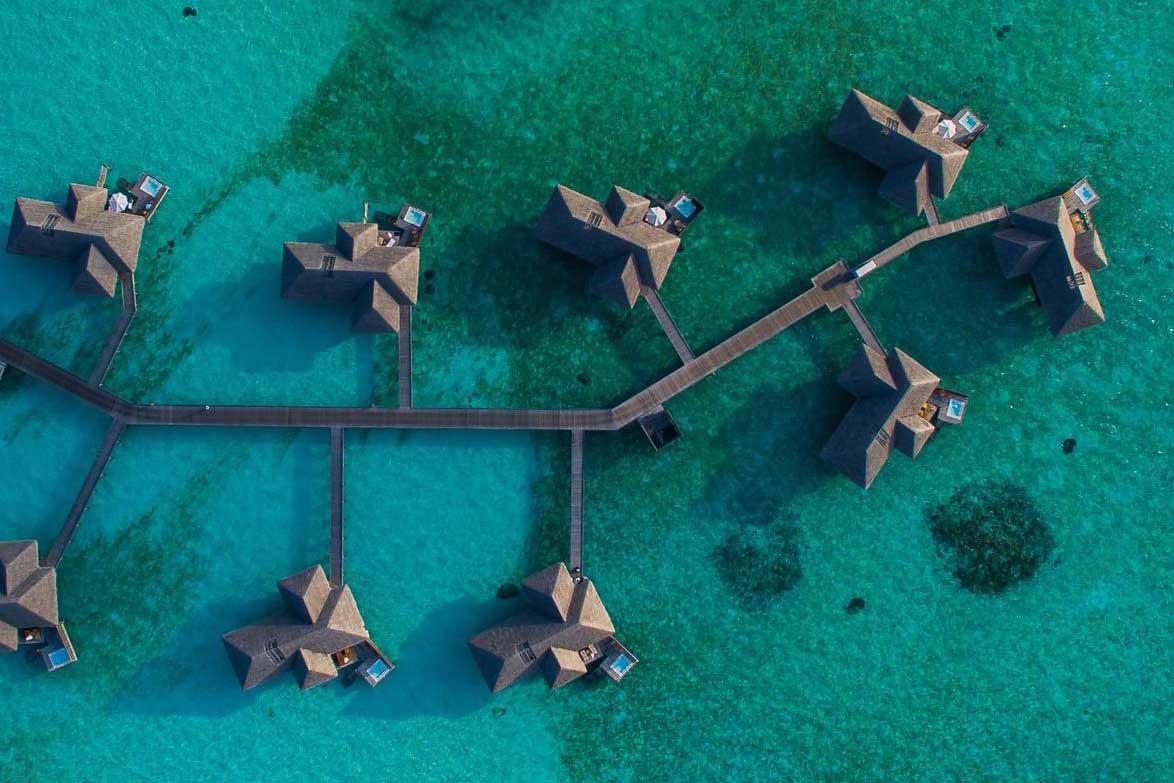 Paradisiacal houses in the shape of an island on the turquoise water