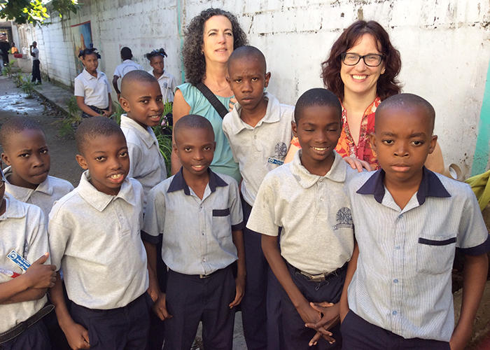 Professor Beverly Baker standing with Haitian students