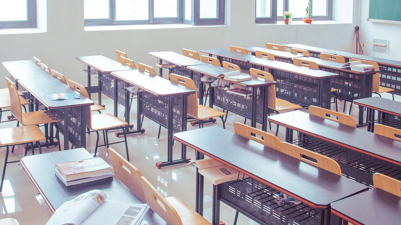 empty classroom filled with desks and chairs